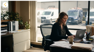 Finance manager reviewing invoice payment options on a laptop at a service company office