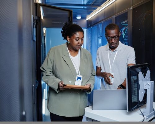Waist up portrait of two black young people as IT engineers using laptop in server room while setting up network SSUCv3H4sIAAAAAAAACnxTy47cIBC8R8o/jDgvEjYGxrnmE5JbtIcG2jNobTMyeKPVav897dcMUR4XC6q6q7uL9vvnT6cTs5CCY19O78uN7qHv55QnyCGOBIunHZ9w9DiVyOsktSgB9CHHKUBfghayu44wIIHj3PcL/LGSLGXIc8K0VN8hBxkvpLGBd4mtxR/b/XQQK0kZRLHvSFViHy9v7Klg02wX9mscbnPGKbGD2+r9Q+ybCzg6/JvSQ2A7PB9zwoVS3h5dE+QnhCHlsM5+b56I34Tb6q55iC0zh0vK0b3crjHH/6X/Odrzdlgb3G2dsEfYnN6FGOi60rJC7gENbzoNHDopuQV5htoIYTp/FGJee3v2tuNO1Io3UlpuURmuaueEbsGo9hGsndQKteVGgeNNi4qCjeaVqZVG4x269h4shRNCm5baUMgbKxZlaLgBDcZpkPK8+bN5w15+0qxDuTIw+xCLbXmNDvolQBYG3Kbgwngp0mK+rut8pLk4j3laHvDuL+tjvIHtl+frSBMP/AopUbg/8KKQo58nDkWdMebV912Vedrw5VpJKcS5amplqqppjKr3gO2vuAbSWds5hNZ1CL4cPSwd0AIpWxsgvzskCzV9rO0krwE6Y7Vt2qomCz9+AQAA//8DAPkil23wAwAA
